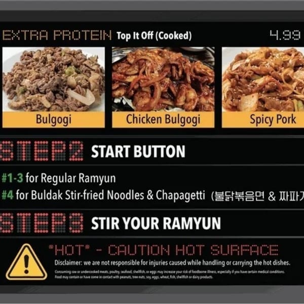 A menu board displaying cooked Bulgogi, Chicken Bulgogi, and Spicy Pork options for Korean BBQ.